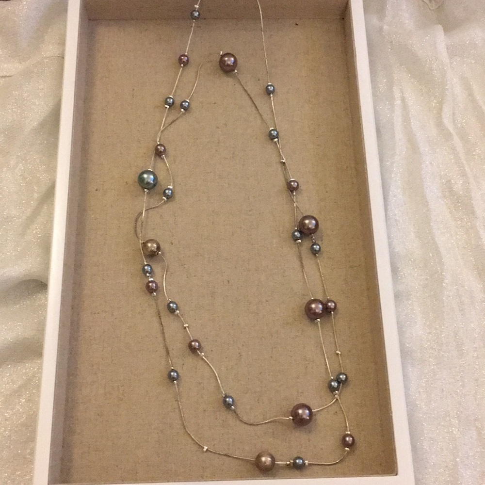 Long multi-color pearl and silver necklace.
